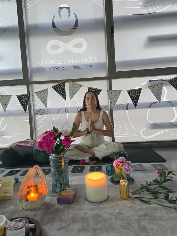 Birthday woman meditating in front of the altar with candles and flowers